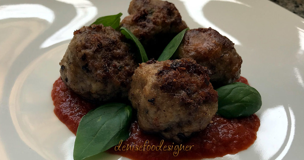 BEEF MEATBALLS BLENDED WITH BEER ON BLACK TOMATO SAUCE